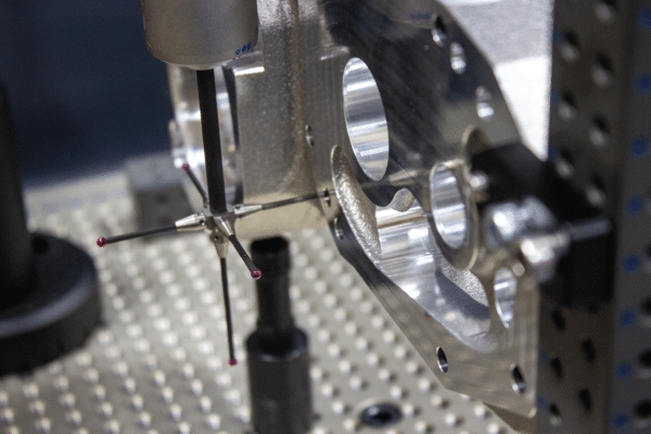 In-process dimensional inspection using a CMM probe to verify tolerances on a CNC machined component at Rainhouse